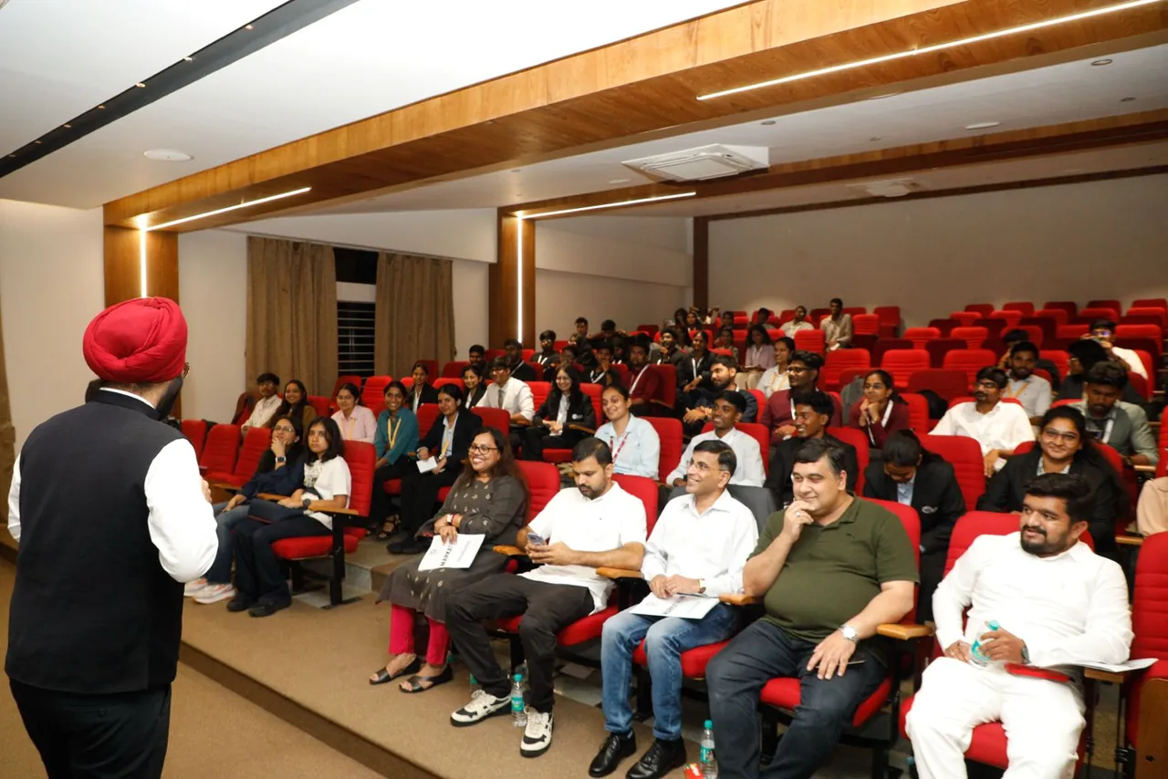 A speaker addressing participants in an auditorium